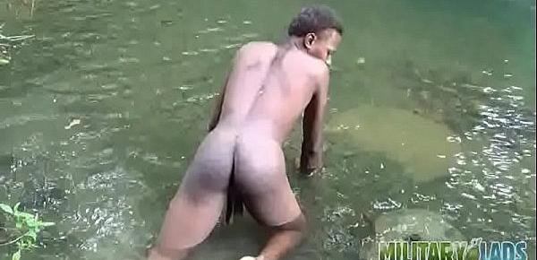  Brown soldier strips naked by the stream